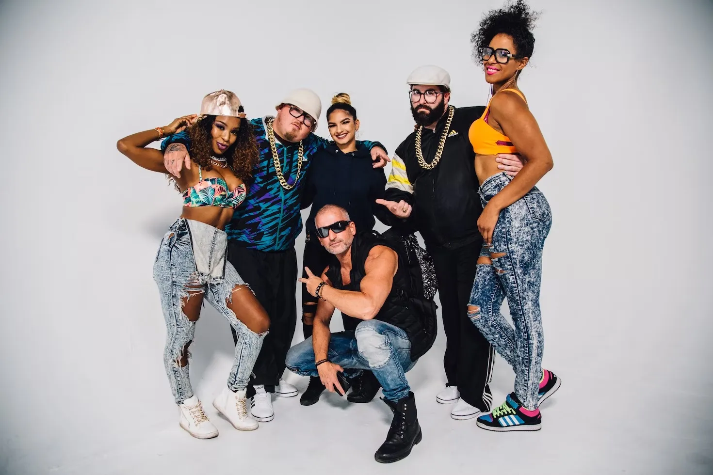 group of friends dressed up in 90s fashion against a white background