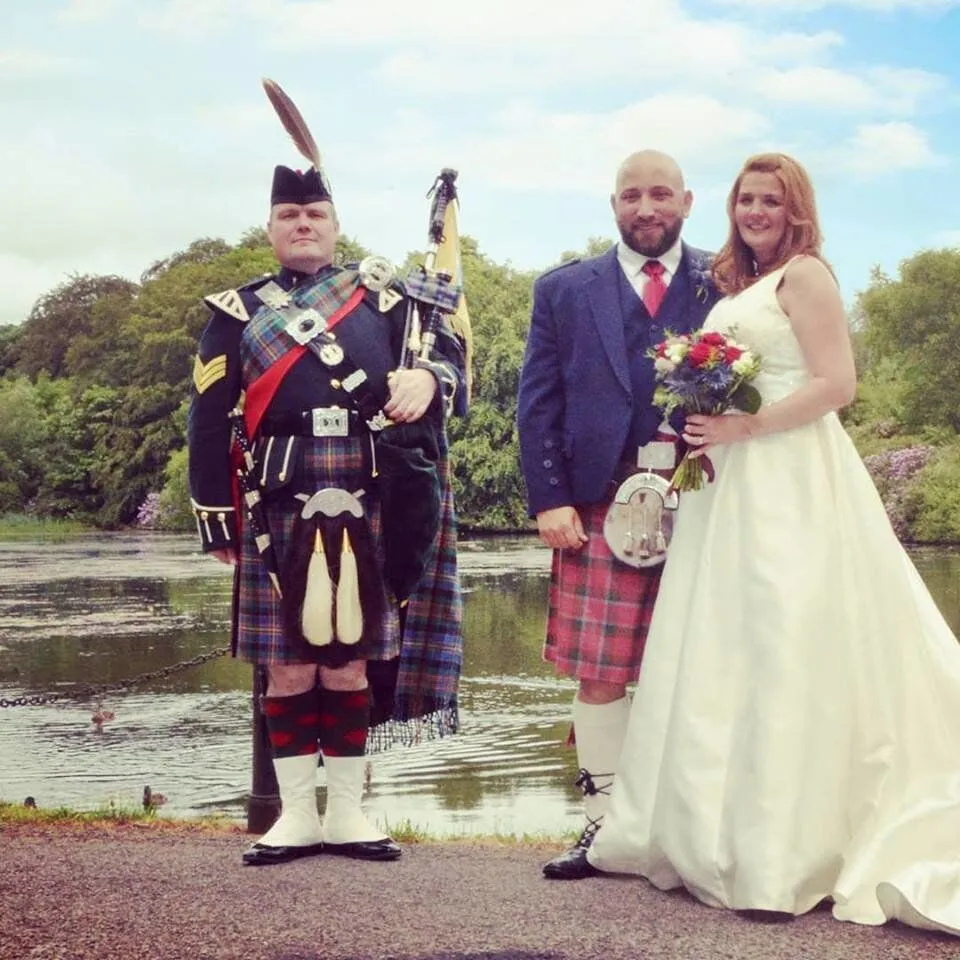 Andy the Piper with wedding couple