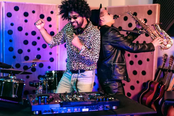 Young happy people playing music with dj mixer and saxophone in house studio - Youth musician entertainment concept