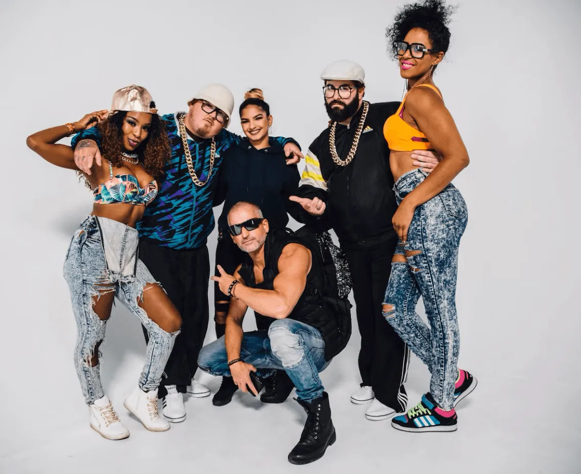 group of friends dressed in 1990s fashion infront of white background