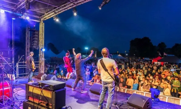view from stage of band performing to large crowd