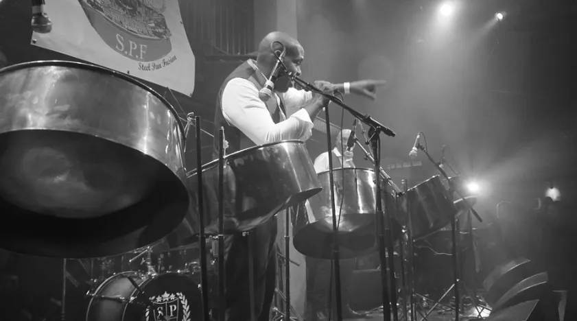 close up, black and white photo of a steel drum playing an event