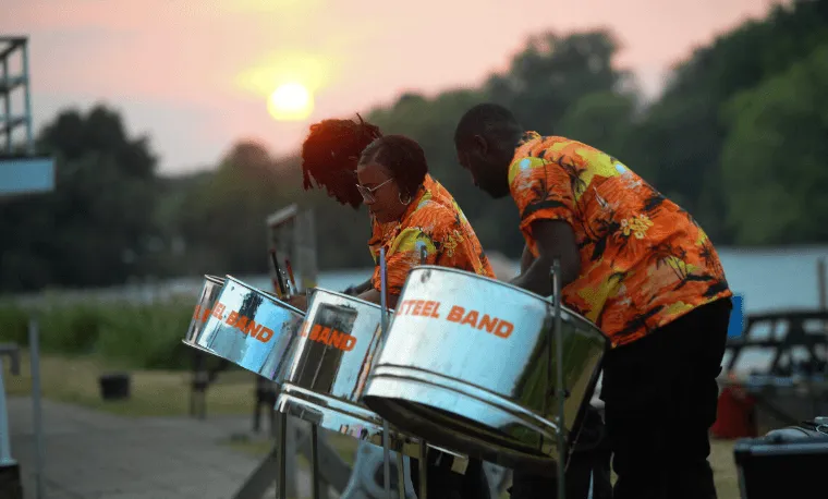 steel drum playing with the sun setting in the background