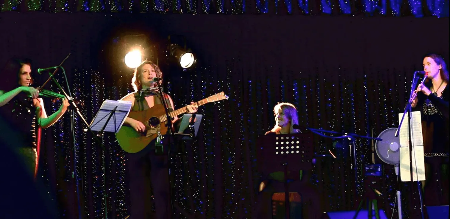 ceilidh band playing infront of a starry background 