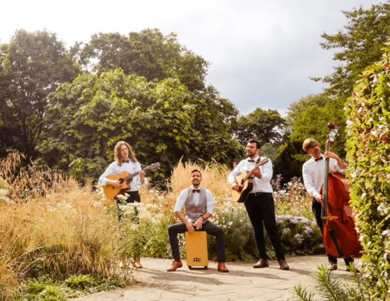 roaming band poses in garden 