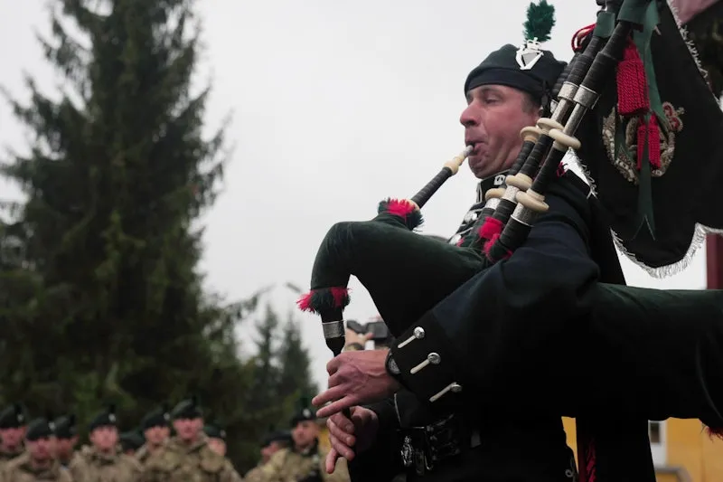 bagpiper in ceremonial attire playing