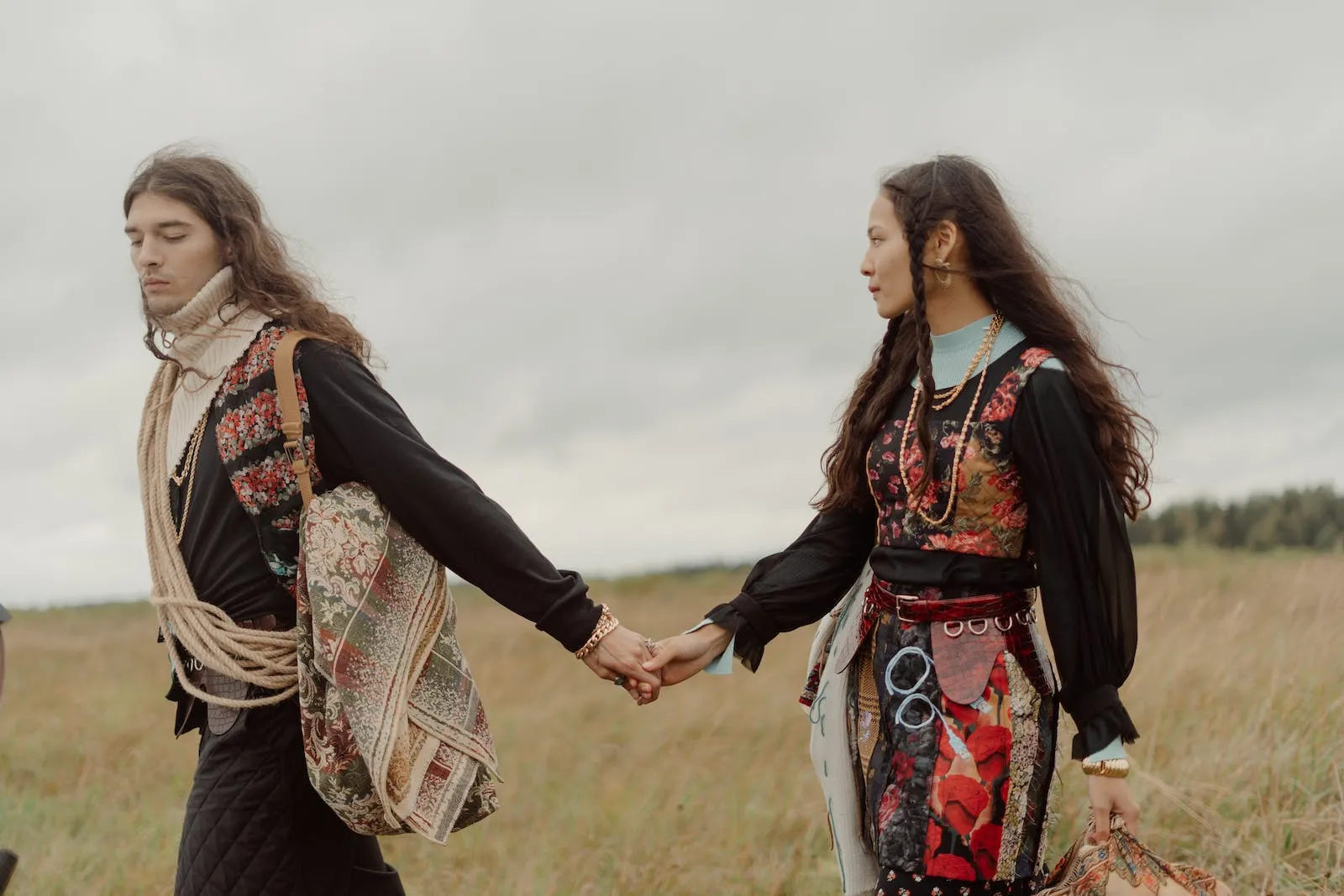 couple in boho theme holding hands