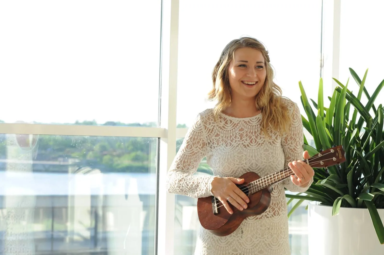 Bride with ukulele performing as a wedding musician at her own wedding!