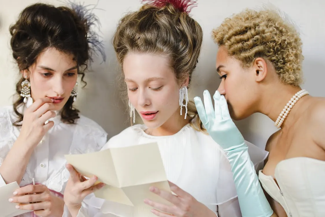 3 women in regency themed outfits