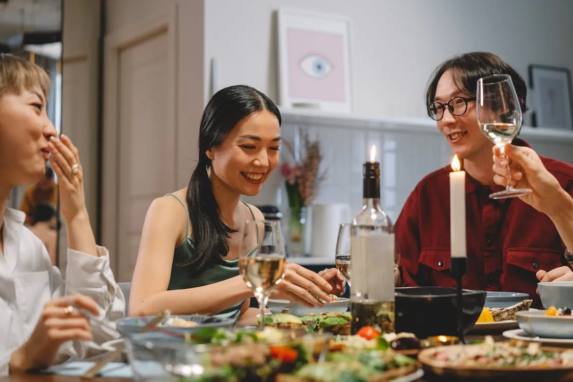 Three friends enjoying a dinner party