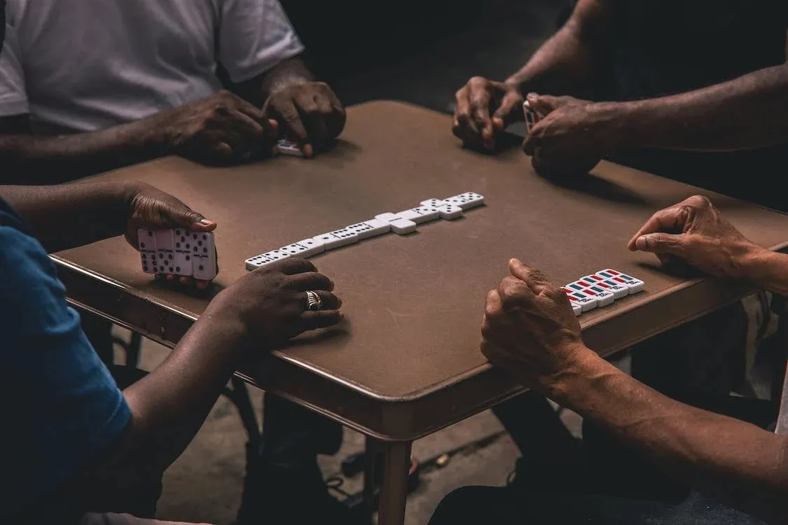 group of 4 men playing dominoes