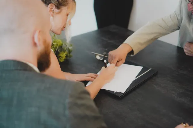 close up of couple signing the wedding register