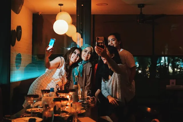 group of friends taking a selfie at a party