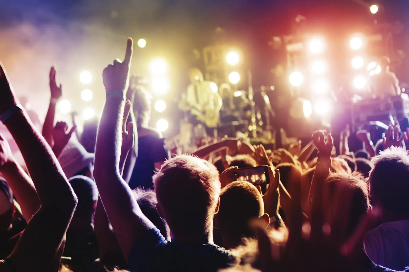 band playing in a fully packed room of party goers