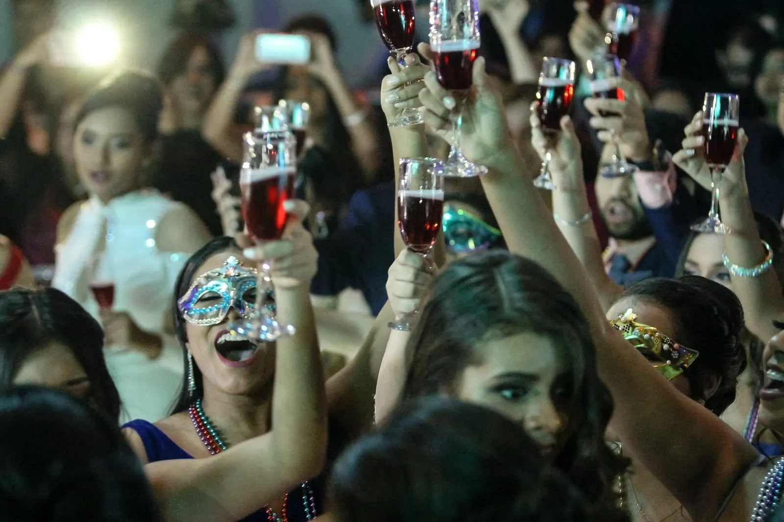masquerade party with crowd dancing