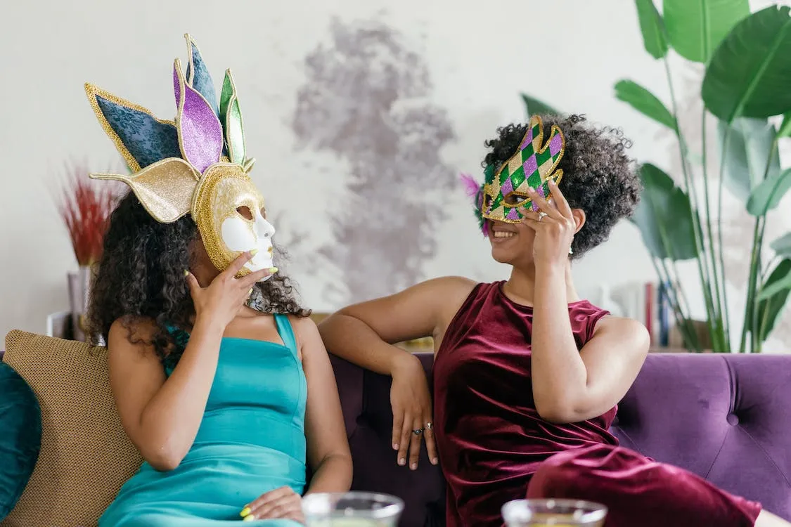 two woman in masquerade/ mardi gras masks