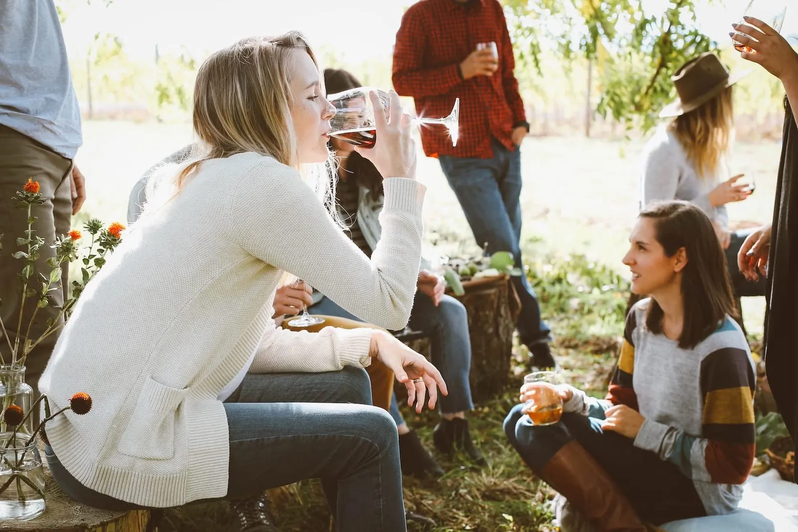 friends in the garden drinking wine and chatting