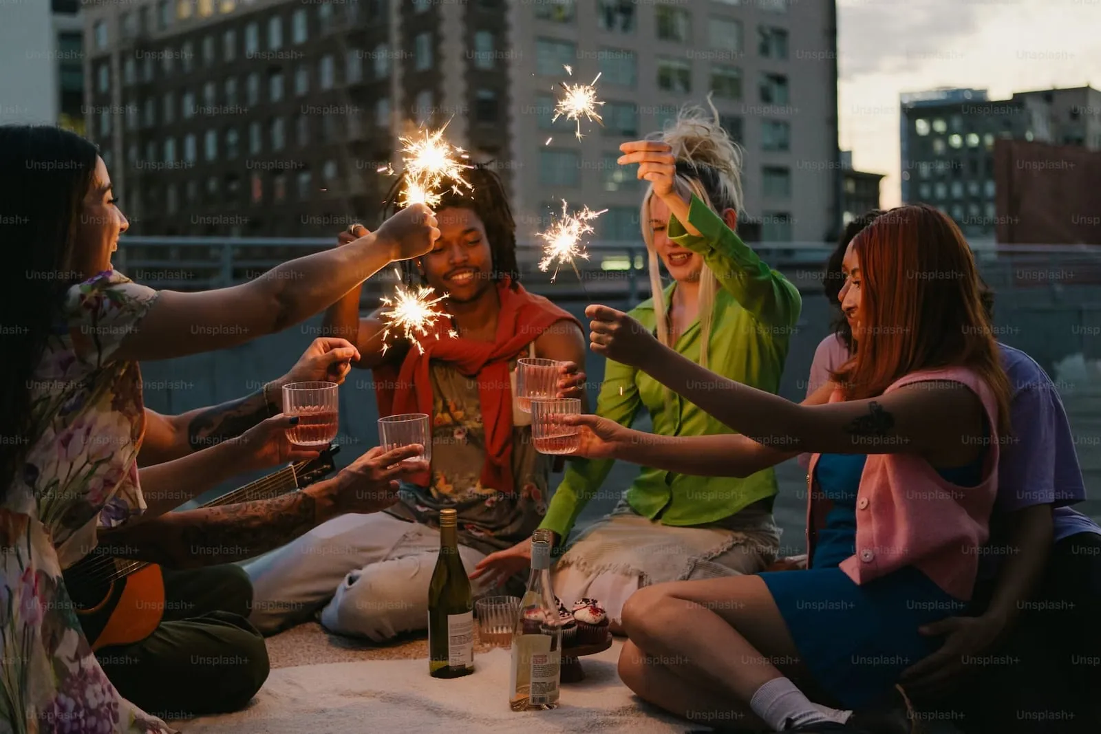 group of friends on a rooftop with sparklers