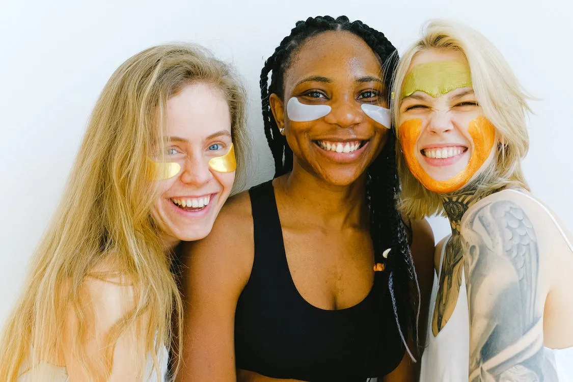 three women wearing eye masks smiling