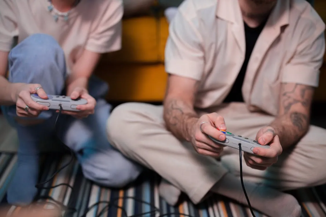 close up of man and woman playing a retro video game