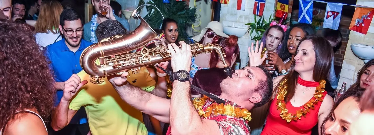 saxophone player playing in a dancing crowd