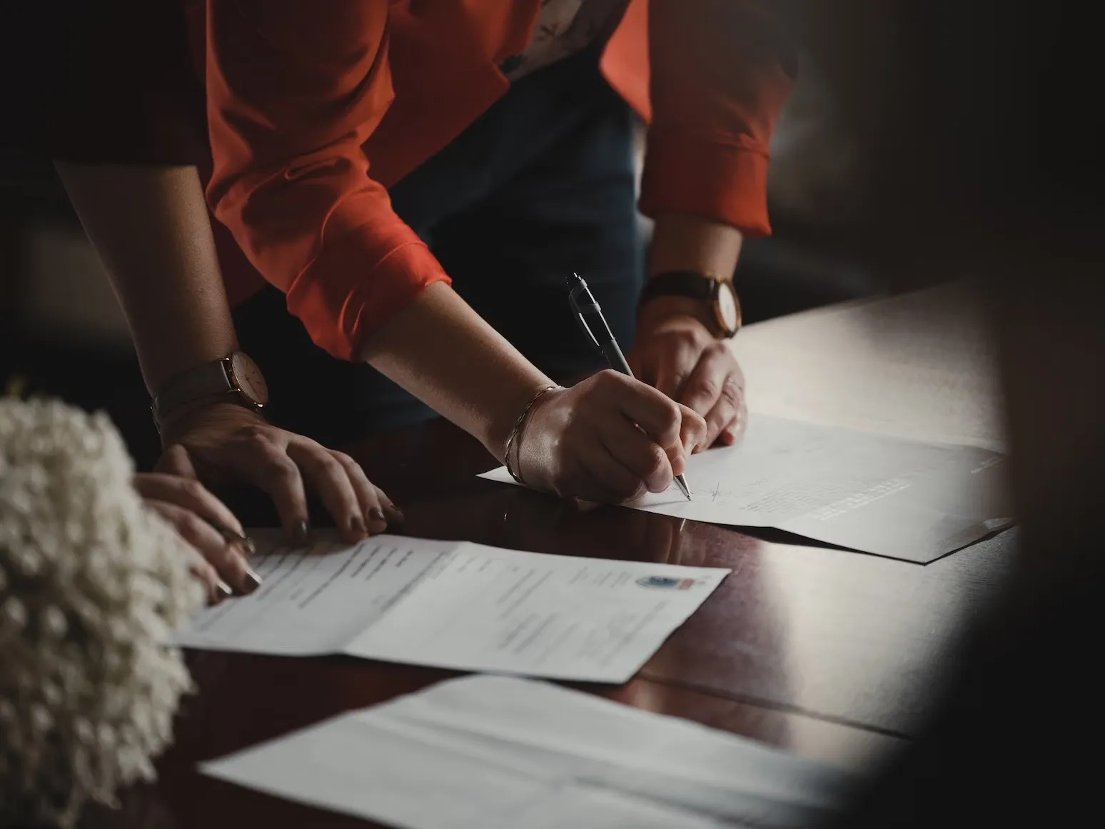 close up of a couple signing the wedding register